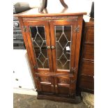 LEAD GLAZED AND CARVED OAK MEDIA CABINET