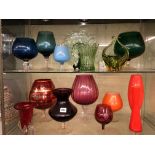 TWO SHELVES OF SIXTIES AND SEVENTIES COLOURED GLASS WARES INCLUDING TANGERINE SPILL VASES,