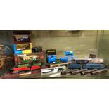 SHELF OF BOXED DIECAST MODELS AND PECO NARROW GAUGE TRAIN ROLLING STOCK MODELS AND LOCOMOTIVES