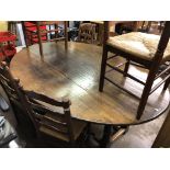 OAK OVAL DROP FLAP WEIGHT TABLE AND EIGHT RAFFIA SEATED LADDER BACK CHAIRS