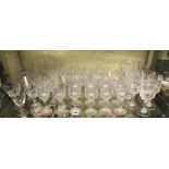 SHELF OF CUT GLASS DRINKING GLASSES