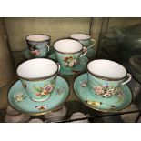 FIVE 19TH CENTURY TURQUOISE GILT BUTTERFLY AND FLORAL TEACUPS AND SAUCERS