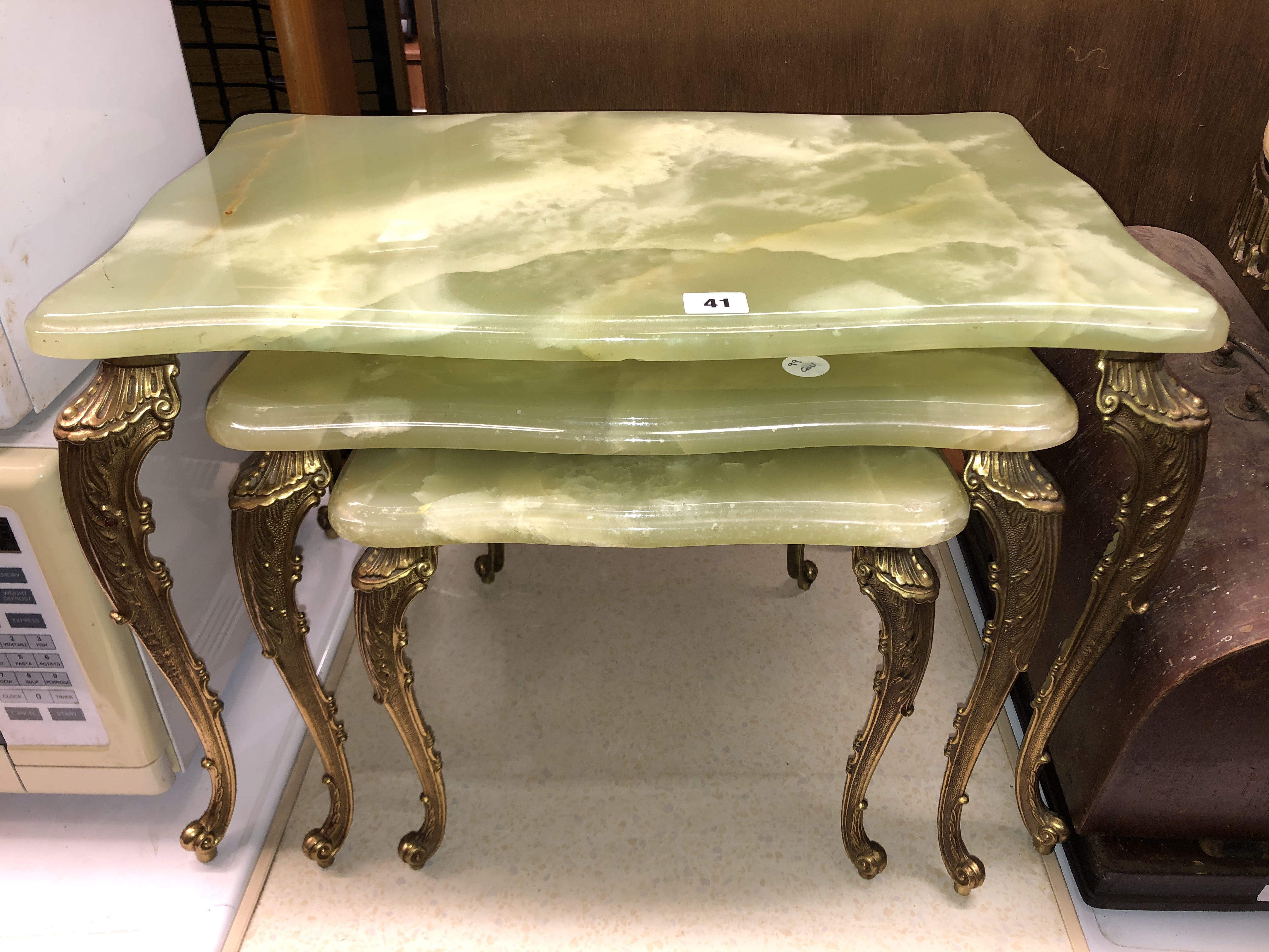 NEST OF THREE SIMULATED ONYX AND GILT CABRIOLE LEG TABLES