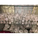 TWO SHELVES OF MAINLY 19TH CENTURY/EARLY 20TH CENTURY DECANTERS, ETCHED GLASSWARE, CELERY VASE,