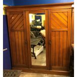 LATE VICTORIAN WALNUT COMPACTUM WARDROBE WITH CENTRAL MIRRORED DOOR ENCLOSING SLIDING TRAYS AND