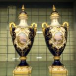 PAIR OF COALPORT BLEU DE ROI AND GILDED OVAL TWIN HANDLED VASES AND COVERS WITH OVAL LANDSCAPE