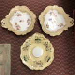 PAIR OF 19TH CENTURY CREAM AND GILT SHALLOW DISHES PAINTED WITH BOTANICAL SPRAYS AND ONE OTHER