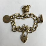 9CT GOLD BRACELET WITH HEART PADLOCK AND A FEW CHARMS 31.