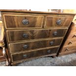 EDWARDIAN MAHOGANY CROSSBANDED AND CHEVRON STRUNG TWO OVER THREE DRAWER CHEST ON BRACKET FEET