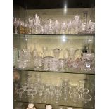 THREE SHELVES OF VARIOUS DRINKING GLASSES, DECANTERS, SUNDAE BOWLS,