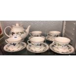ROYAL DOULTON BURGUNDY PATTERN TEAPOT AND FIVE CUPS AND SAUCERS