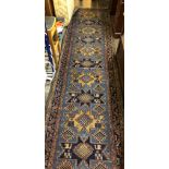 EARLY 20TH CENTURY BLUE GROUND CAUCASIAN RUNNER 92 X 358CM APPROX
