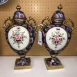 PAIR OF JAPANESE NORITAKE BLUE FLORAL AND GILT TWIN HANDLED VASES WITH COVERS A/F (FINIAL RE-GLUED)