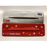 CARANDACHE 849 ORIGINAL PEN WITH GOLIATH REFILL AND ONE OTHER IN THE SWISS FLAG COLOURS (TWO PENS