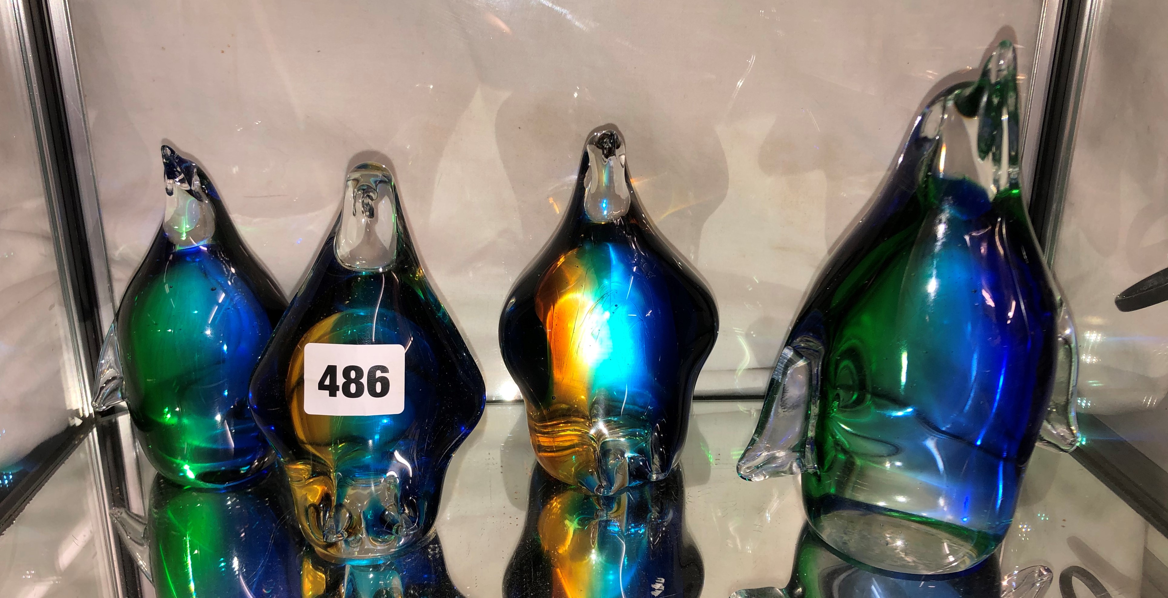 FAMILY OF FOUR GLASS COLOURED LIMITED EDITION PENGUINS