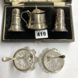 CASED SILVER BALUSTER THREE PIECE CONDIMENT SET AND A PAIR OF SILVER RIMMED TABLE SALTS AND SPOONS