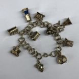 SILVER CHARM BRACELET INCLUDING TANKARD, MINERS SAFETY LAMP, BELL,