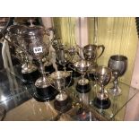 SILVER TWIN HANDLED CUP ON BAKELITE SOCLE AND AN EPNS TWIN HANDLED ENGRAVED CUP AND COVER AND