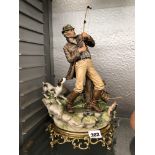 CAPO DI MONTE FIGURE GROUP OF A FISHERMAN ON GILT METAL BASE,