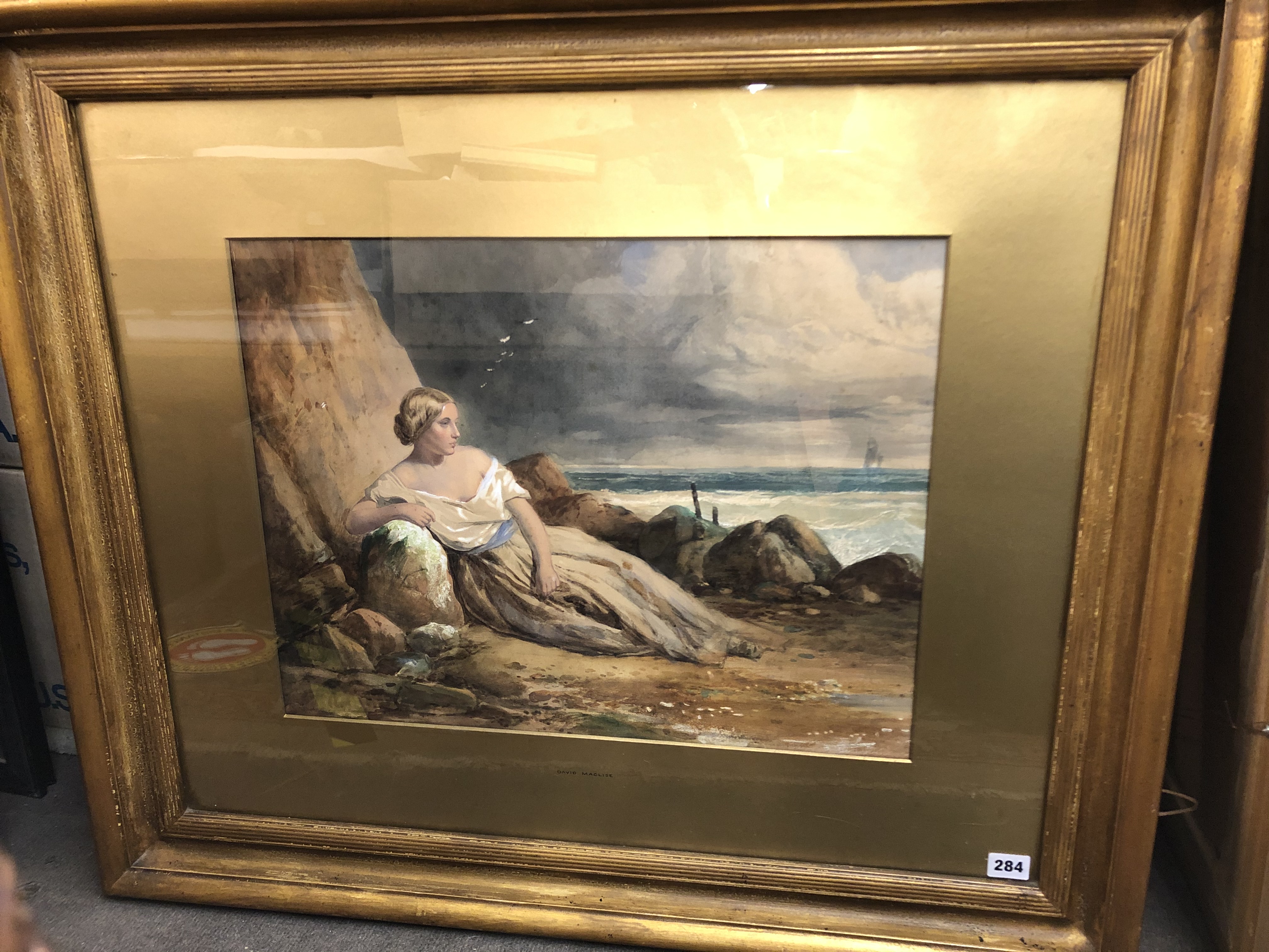 DAVID MACLISE WATERCOLOUR HEIGHTENED IN GOUACHE OF A FEMALE RECLINING BY ROCKS ON A BEACH F/G 53 X