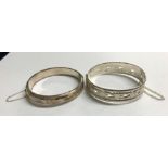 TWO SILVER ENGRAVED BANGLES WITH SAFETY CHAINS