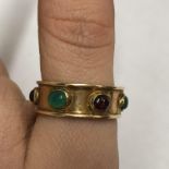 UNMARKED BROAD YELLOW METAL BAND SET WITH CABOCHON STONES, SIZE T 7.