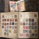WORLD POSTAGE STAMP ALBUM AND A SMALL BOOKLET OF STAMPS INCLUDING PENNY REDS AND BLUES,