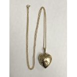 9CT GOLD HEART SHAPED LOCKET ON AN UNMARKED TRACE CHAIN 5.
