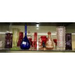 SHELF OF COLOURED GLASSWARE,