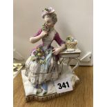 MEISSEN FIGURE OF A SEATED 18TH CENTURY LADY WITH A BASKET OF FLOWERS ,