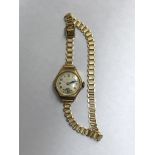 LADIES 18CT GOLD CASED WRIST WATCH ON PLATED STRAP 17.