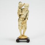 A Ivory Okimono of an Old Man with Child, height 9.2 in — 23.4 cm