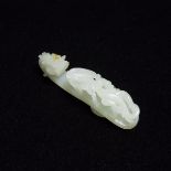 A White Jade Belt Hook with Russet Skin, Qing Dynasty, 清 白玉雕'苍龙教子'带钩, length 3.5 in — 9 cm