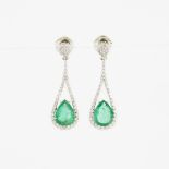 Pair Of 18k White Gold Drop Earrings, each set with a pear cut emerald (1.62ct. each) and decorated