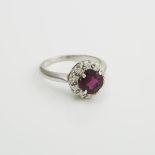 18k White Gold Ring, set with a full cut rhodolite garnet (approx. 1.15ct.) and 10 small brilliant c