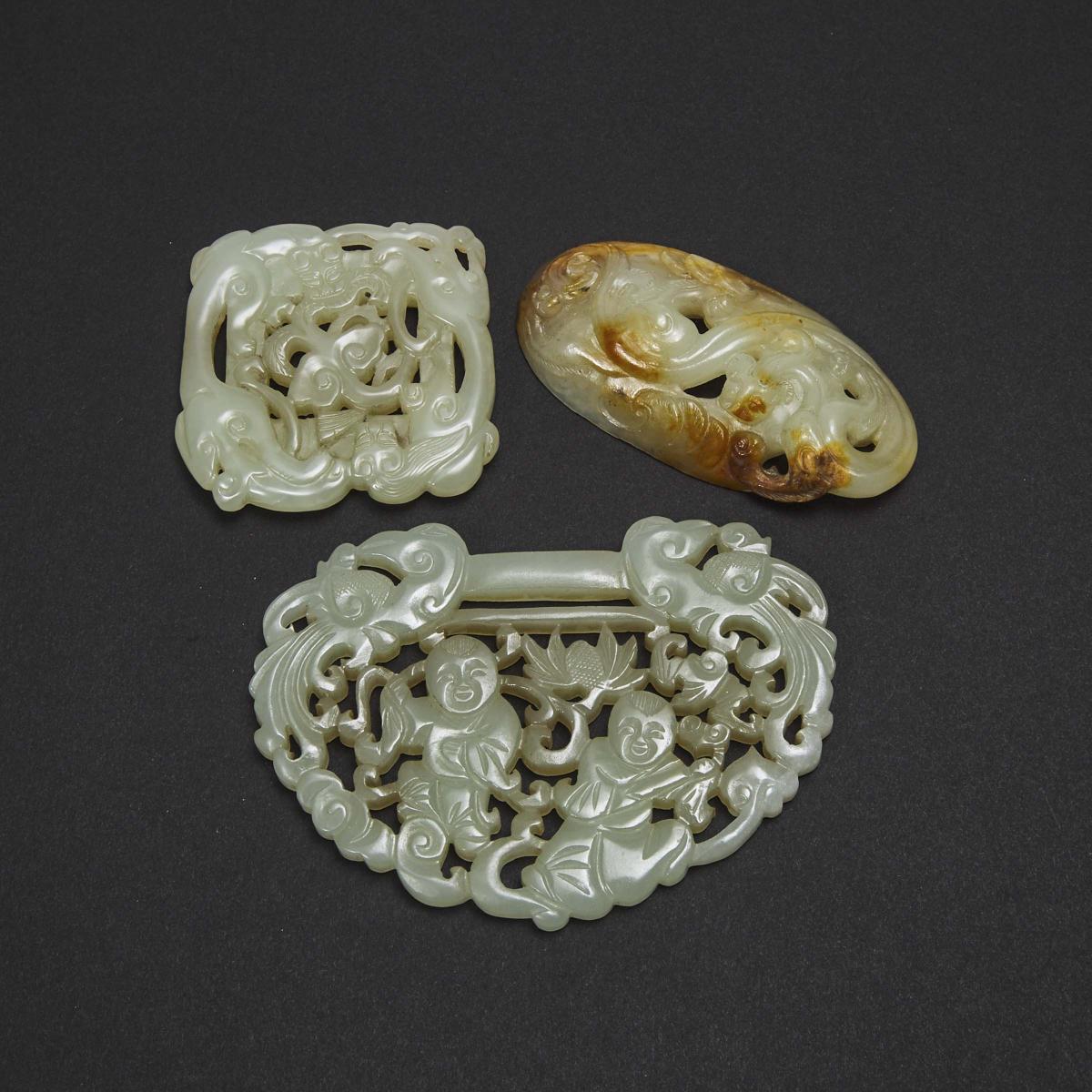 A Group of Three Reticulated Jade Carvings, 青白玉雕童子持莲锁片 螭龙衔灵芝纹佩 螭龙海水纹牌一组三件, largest 2.6 x 3.5 in — 6.