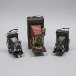 Three Folding Pocket Cameras, early to mid 20th century, tallest height 10 in — 25.4 cm (3 Pieces)