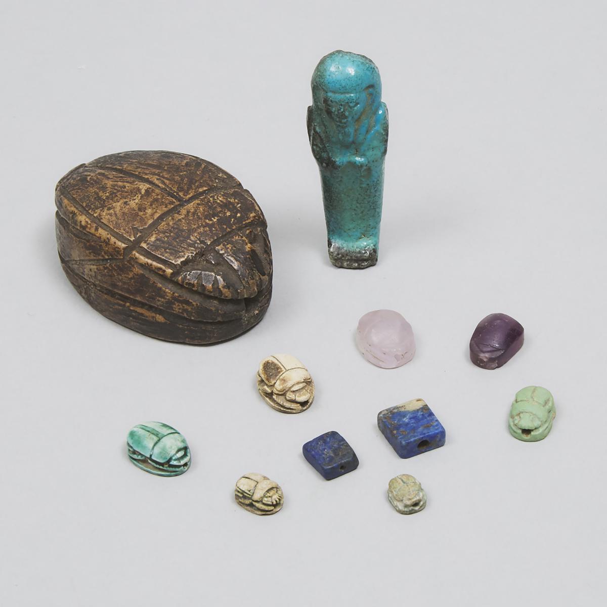 Group of Eight Egyptian Faience and Mineral Scarabs and an Ushabti, Third Intermediate Period and La