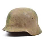 A Third Reich M35 steel helmet, with rough textured camouflage finish, no decals, maker’s mark ‘