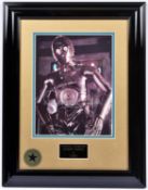 A Star Wars framed photograph of C3PO with signed autograph by actor Anthony Daniels. In gloss black