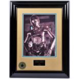 A Star Wars framed photograph of C3PO with signed autograph by actor Anthony Daniels. In gloss black