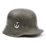 A German M18 steel helmet, with smooth grey finish and added SS decal, faint ‘SE66’ maker’s mark (