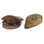 An officer’s khaki peaked cap of The Middlesex Regt, brown leather chinstrap, bronzed badge and