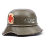 A Third Reich Luftschutz ‘gladiator’ helmet, with smooth khaki finish, Luftschutz decal, and painted