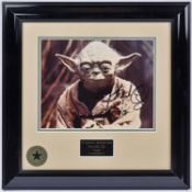 A Star Wars framed photograph of Yoda with signed autograph by actor Frank Oz. In gloss black
