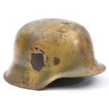 A Third Reich M42 steel helmet, with camouflage finish, the single decal removed, maker’s mark ‘