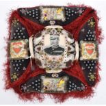 A Boer War pin cushion, in the form of Maltese Cross with studded charcoal grey panels edged with