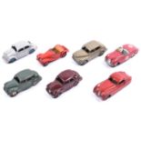 7 Dinky Toys. 2x Austin Devon in maroon and in sage green, with cream and maroon wheels.