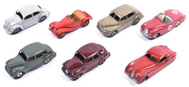 7 Dinky Toys. 2x Austin Devon in maroon and in sage green, with cream and maroon wheels.