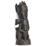An African carved darkwood figure of a double deity, the top figure’s head with pointed ears and row